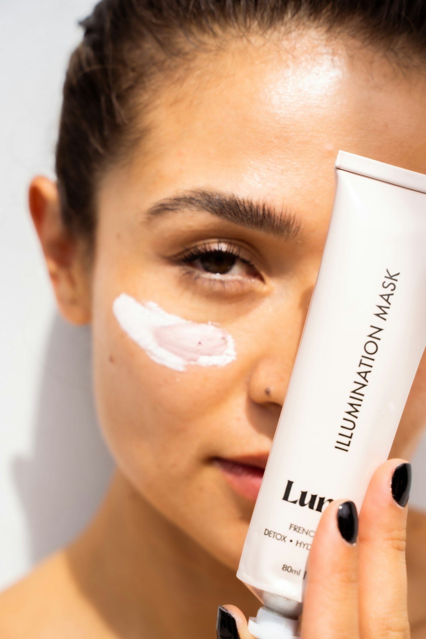 Woman with white cream on face