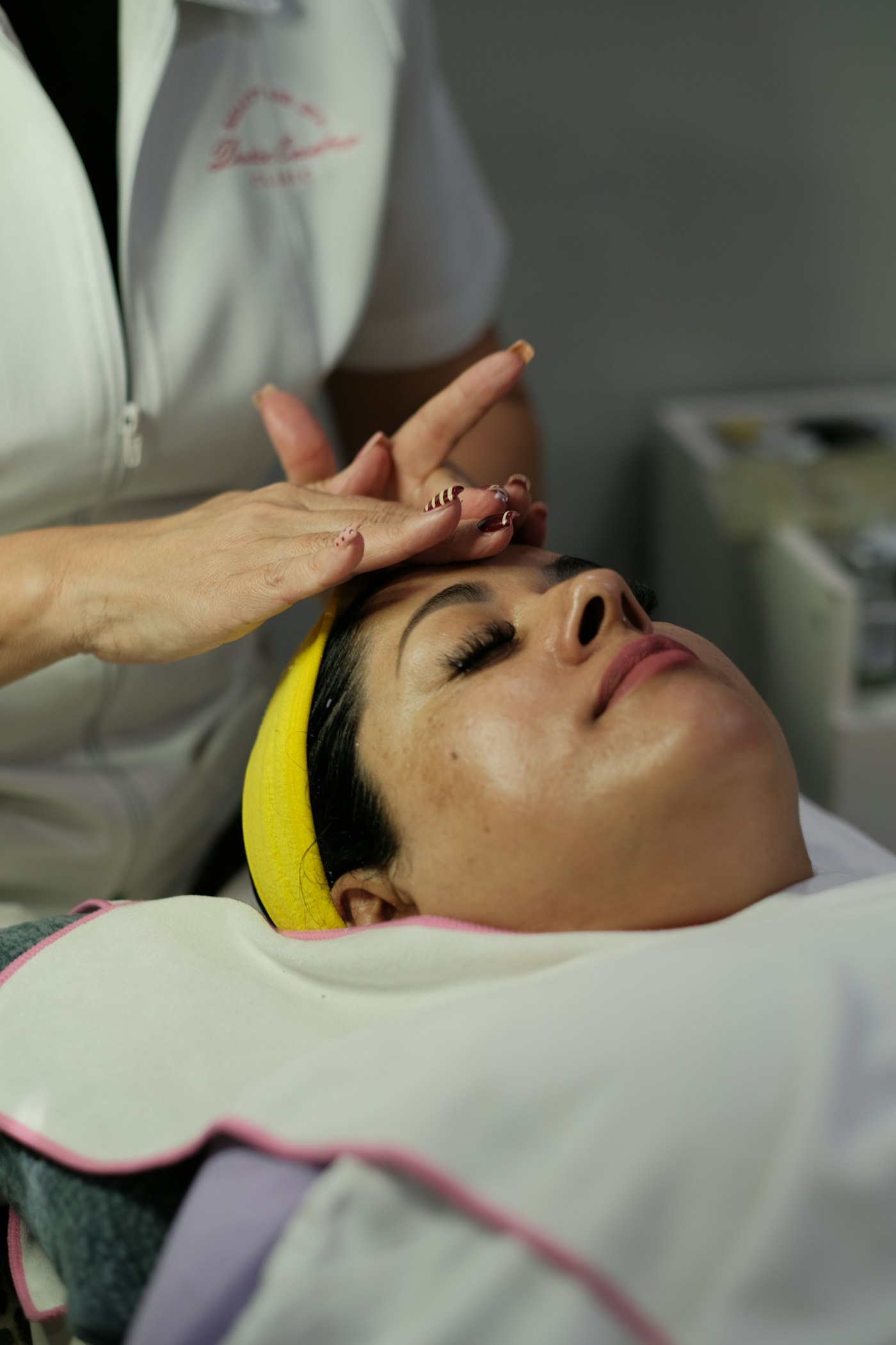 Woman receiving a facial treatment at a spa